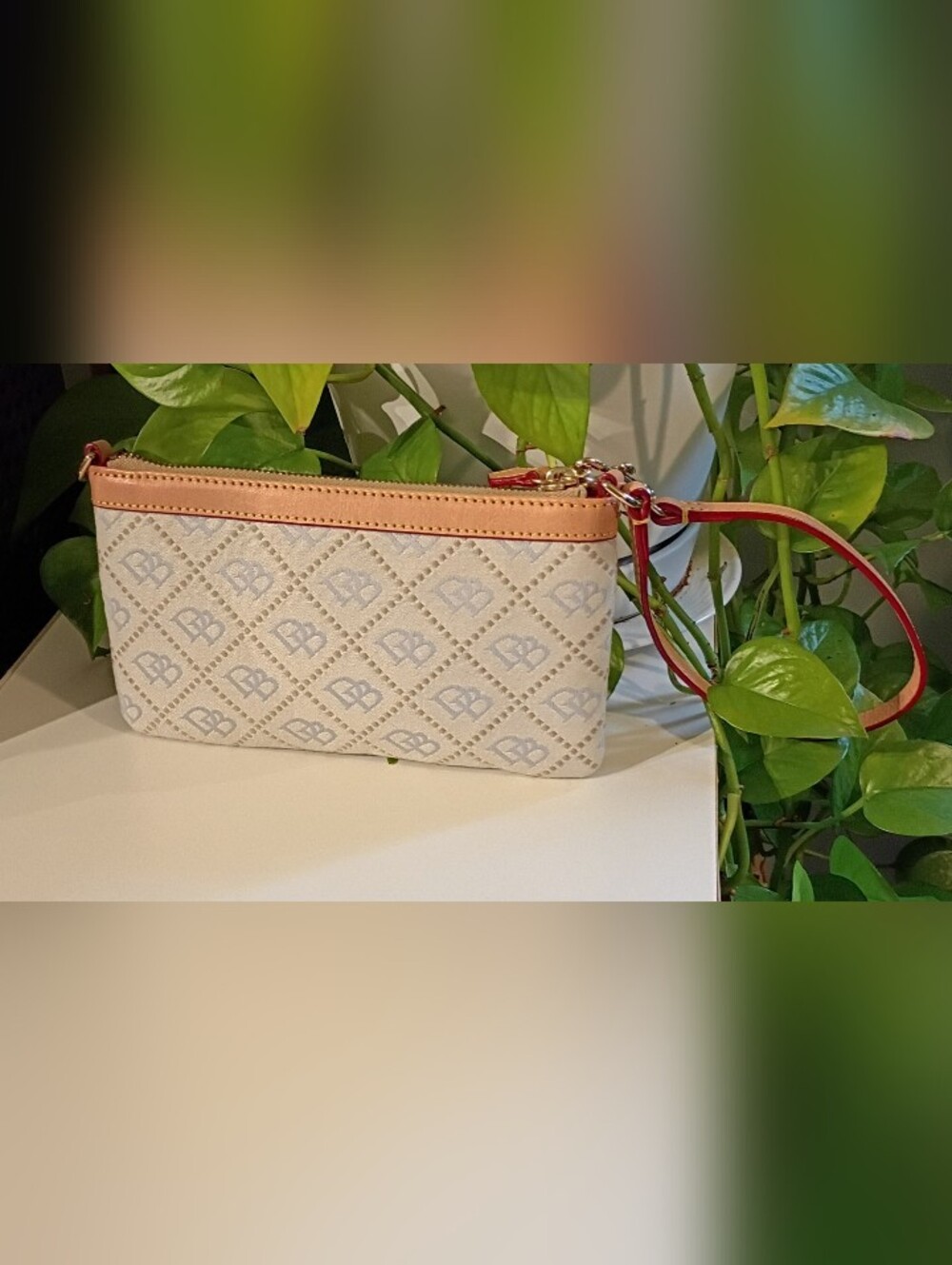 Dooney & Bourke Cream Monogram Wristlet with Tan Trim and Red Strap